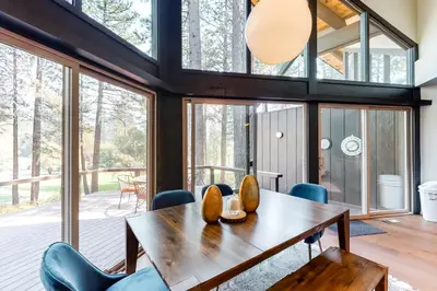 a dining room with a wooden table and chairs at Among the Trees in Incline Village