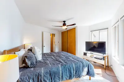 a bedroom with a bed and a flat screen tv at Among the Trees in Incline Village