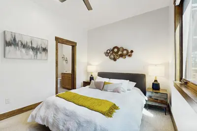 a bedroom with a bed with a yellow blanket on it at Truckee Treat in Truckee