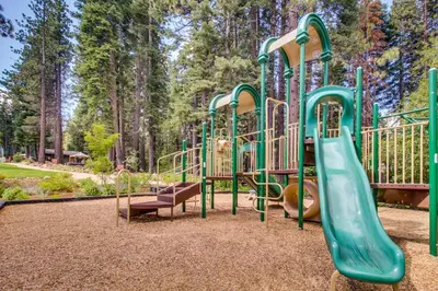 a playground with a slide in a park at Cheery Gold Bend Family Condo in Truckee