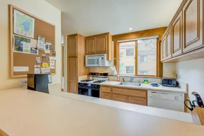 a kitchen with a sink and a stove top oven at Cheery Gold Bend Family Condo in Truckee