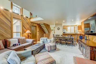 a living room with a couch and a table at Cheery Gold Bend Family Condo in Truckee