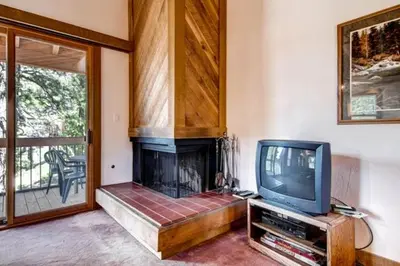 a living room with a fireplace and a tv at Less Than 1 Mile to Northstar Resort Getaway with Balconies in Truckee