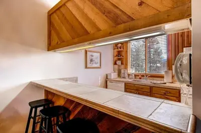 a kitchen with a counter and a sink and a window at Less Than 1 Mile to Northstar Resort Getaway with Balconies in Truckee