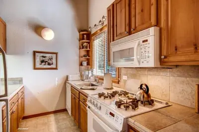 a kitchen with a stove and a microwave at Less Than 1 Mile to Northstar Resort Getaway with Balconies in Truckee