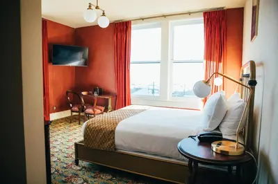 a hotel room with a bed and a window at Belvada Hotel in Tonopah