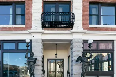 a building with two statues on the front of it at Belvada Hotel in Tonopah