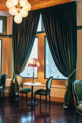 a room with a table and chairs and a window at Belvada Hotel in Tonopah