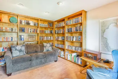 a living room with a couch and book shelves at Homewood Bliss in Homewood