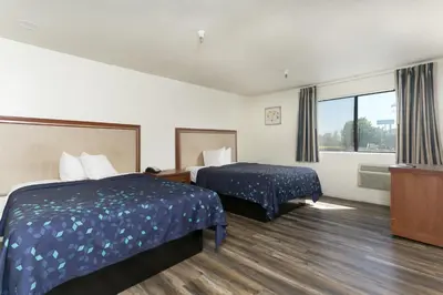 a hotel room with two beds and a window at Waterloo Inn in Stockton