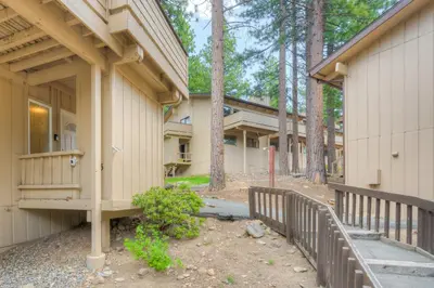 a building with a porch next to a fence at Linda's Lakehouse in Incline Village