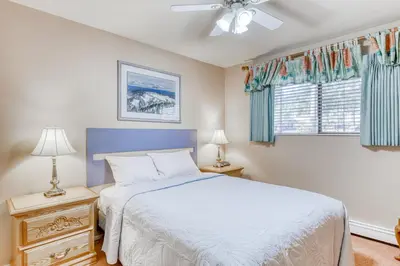 a bedroom with a white bed and a window at Incline Oasis in Incline Village