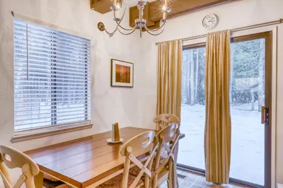 a dining room with a wooden table and chairs at Eska's Escape in Soda Springs