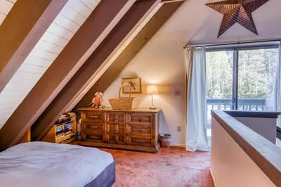 a attic bedroom with a bed and a window at Eska's Escape in Soda Springs
