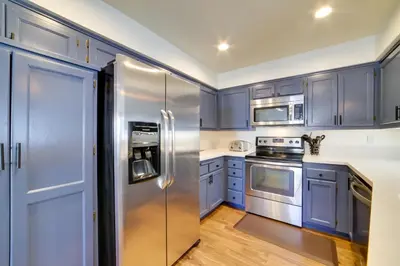 a kitchen with blue cabinets and stainless steel appliances at Snowcreek Resort Condo with Deck at Mammoth Mountain in Mammoth Lakes