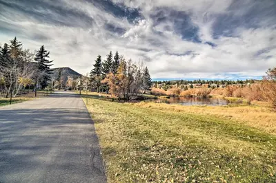 a road next to a field and a river at Snowcreek Resort Condo with Deck at Mammoth Mountain in Mammoth Lakes