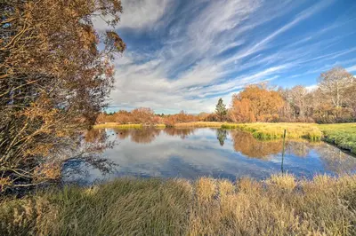 a river with trees and a blue sky at Snowcreek Resort Condo with Deck at Mammoth Mountain in Mammoth Lakes