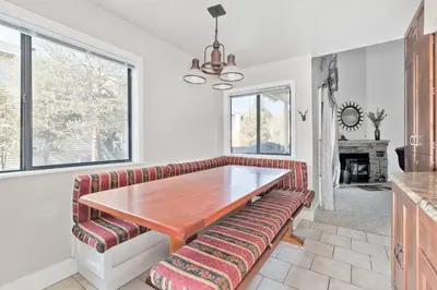a dining room with a wooden table and a couch at La Vista Blanc 78 in Mammoth Lakes