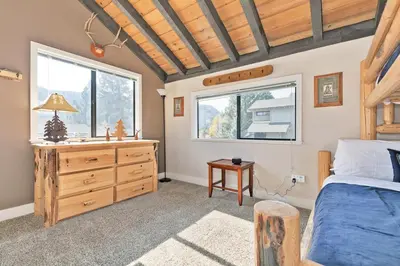 a bedroom with a bed and a dresser and a window at La Vista Blanc 78 in Mammoth Lakes