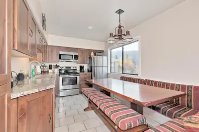 a kitchen with a wooden counter top and a table at La Vista Blanc 78 in Mammoth Lakes