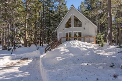 a house with a pile of snow around it at Poma Lane in Soda Springs