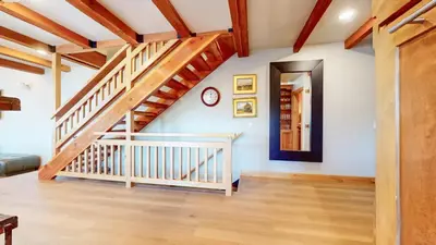 a staircase in a living room with wooden floors at Val DIsere #10 condo in Mammoth Lakes