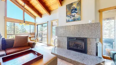 a living room with a fireplace and a couch at Val DIsere #10 condo in Mammoth Lakes