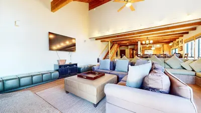 a living room with two couches and a tv at Val DIsere #10 condo in Mammoth Lakes