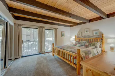 a bedroom with a bed and a large window at Kings Beach Bliss in Kings Beach