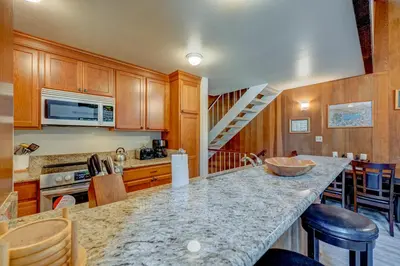 a kitchen with a counter top and a staircase at Kings Beach Bliss in Kings Beach