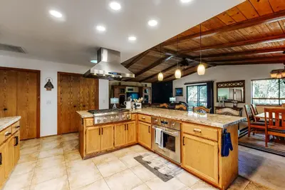 a large kitchen with wooden cabinets and a dining room at Summer Creek in Groveland