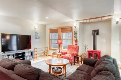 a living room with a couch and a tv at Sugar House in Soda Springs