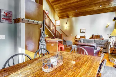 a dining room with a wooden table and chairs at Sugar House in Soda Springs