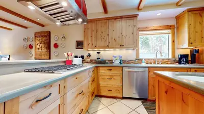 a large kitchen with wooden cabinets and a sink at Val D'Isere #9 condo in Mammoth Lakes