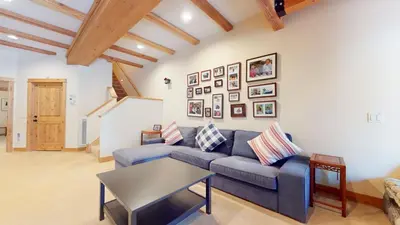 a living room with a blue couch and pictures on the wall at Val D'Isere #9 condo in Mammoth Lakes
