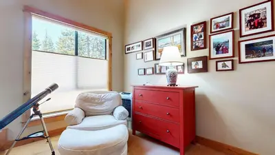 a living room with a red dresser and a chair at Val D'Isere #9 condo in Mammoth Lakes