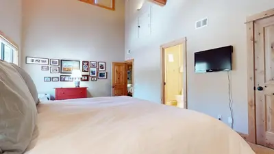 a bedroom with a bed and a flat screen tv at Val D'Isere #9 condo in Mammoth Lakes