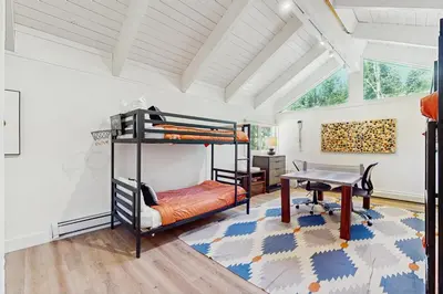 a bedroom with bunk beds and a desk and a table at Bearing Drive Escape in Tahoe City
