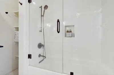 a shower with a glass door in a bathroom at Bearing Drive Escape in Tahoe City
