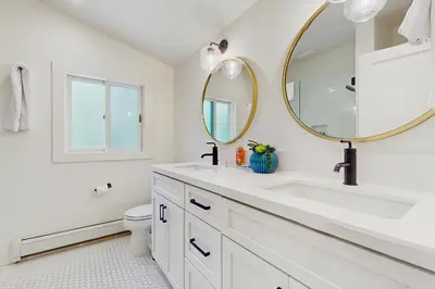 a white bathroom with a sink and a mirror at Bearing Drive Escape in Tahoe City