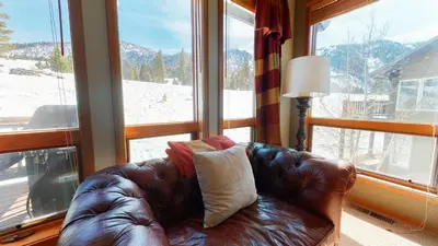 a leather couch sitting in front of a window at Snowcreek V #774 condo in Mammoth Lakes