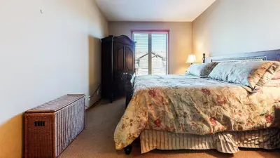 a bedroom with a large bed and a window at Snowcreek V #774 condo in Mammoth Lakes
