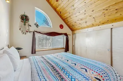 a bedroom with a bed and a wooden ceiling at Boat House in Soda Springs