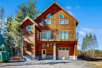 a wooden house with a balcony on top of it at Boat House in Soda Springs