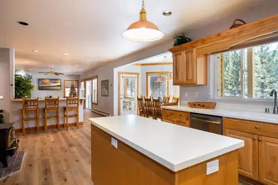 a kitchen with wooden cabinets and a kitchen island at Skidder Trail Family Lodge home in Truckee