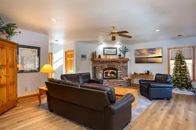 a living room with a couch and a fireplace at Skidder Trail Family Lodge home in Truckee