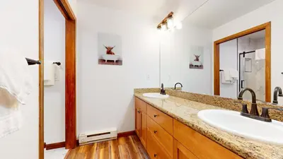 a bathroom with two sinks and a mirror at Eagle Run #103 condo in Mammoth Lakes