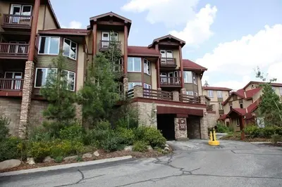 a large apartment building with a yellow fire hydrant in front of it at Eagle Run #103 condo in Mammoth Lakes