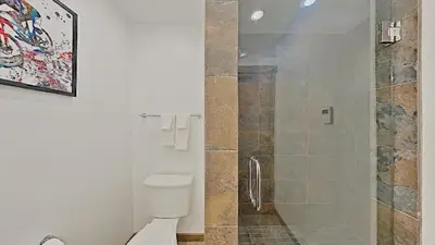 a bathroom with a toilet and a glass shower at 1849 Condos 562 home in Mammoth Lakes