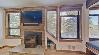 a living room with a fireplace with a tv and a tv at 1849 Condos 562 home in Mammoth Lakes